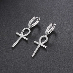 Silver Ankh key cross earrings featuring full cubic zirconia inlays on grey background
