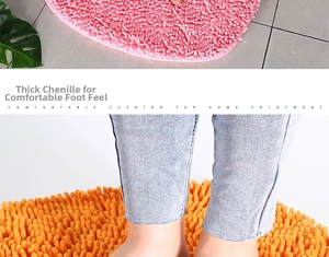 Detail of thick chenille heart bath mat showing plush texture in pink and orange colors