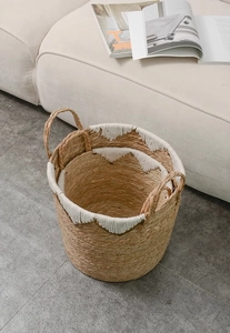 Detail of handwoven seagrass storage baskets with white cotton rim and sturdy handles