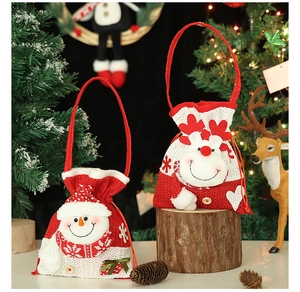 Detail of Christmas gift bags with 3D snowman and reindeer patterns and knit texture