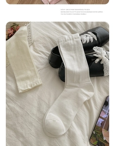 Detail of silk cotton socks in white and beige showing light breathable knit texture