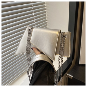 Detail of silver geometric chain bag featuring a metallic luster finish and chic flap closure