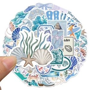 Close-up of coastal girl ocean stickers with starfish and shells on white background