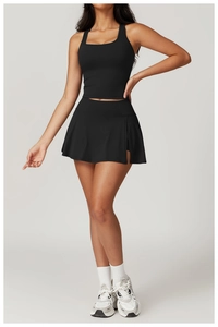 Detail of black racerback tank top and matching high-waisted tennis skirt set for women