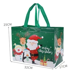 Detail of green non-woven Christmas gift bag with Santa and reindeer motifs