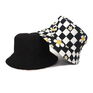 Detail view of cotton bucket hats in solid black and checkered sunflower print patterns