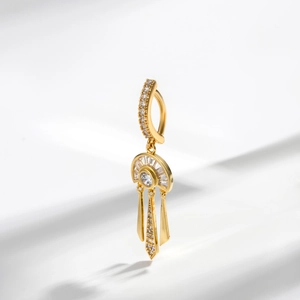 Golden dreamcatcher navel piercing belly ring with sparkling zircon tassels on a white background