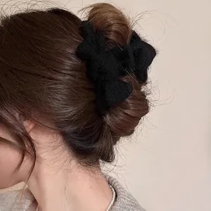 Elegant black plush bow hair claw clip for women stylish winter headwear accessory