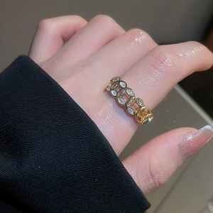 Close-up of 18k gold plated ring with white zircon stones on a model's finger