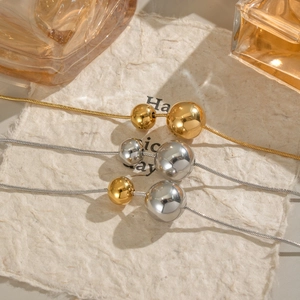 Three minimalist titanium steel necklaces with double sphere pendants in gold and silver