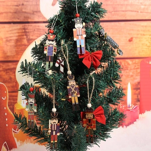 Detailed view of colorful wooden nutcracker soldier ornaments hanging on a Christmas tree