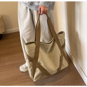 Detail of canvas tote bag with contrast reinforced straps for durability and style