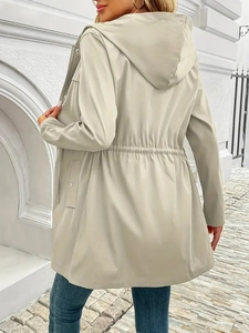 Detail of waist drawstring and zipper on beige hooded windbreaker jacket for women