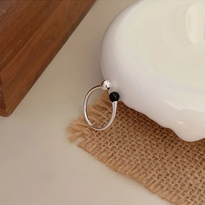 S925 sterling silver open ring with black agate bead in a lifestyle aesthetic setting