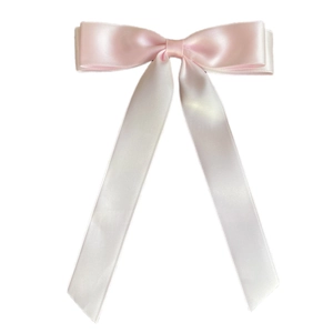Detail of elegant pink satin double bow hair clip with long silk ribbons on white background