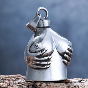 Close-up of vintage stainless steel motorcycle bell pendant with female torso design