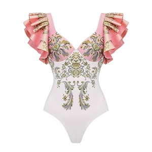 Detail of V-neck one-piece swimsuit featuring ruffled shoulders and floral print