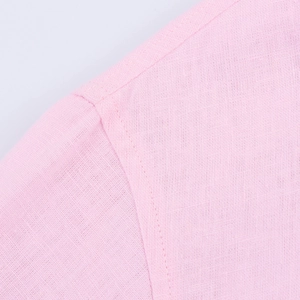 Macro shot of pink linen blend fabric texture and professional stitching on the sleeve