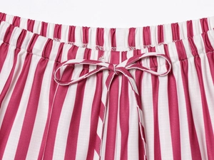 Detail of red and white vertical striped elastic waist shorts with drawstring closure