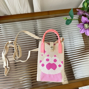 Close-up of beige knit phone bag with pink cat paw pattern and plastic handles