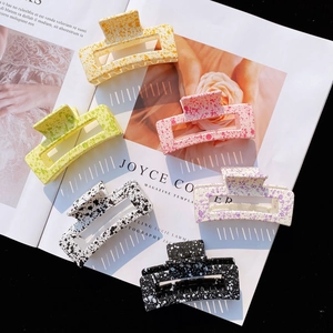 Collection of matte acrylic square hair claws in pastel colors with stylish ink splash patterns