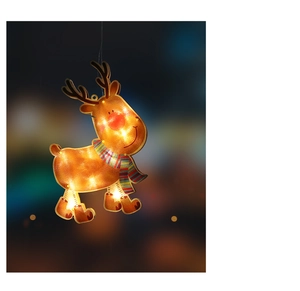 Close-up of a warm glowing LED reindeer Christmas hanging ornament with city night background