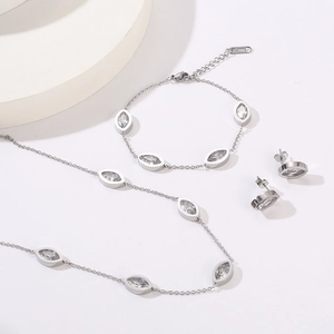 Detail of silver-tone jewelry set with marquise crystals and S-STEEL material hallmark