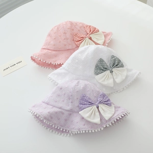 Detailed texture of lace sun hats with polka dot bows and pom-pom trim for toddler girls