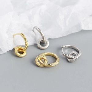Detail of twisted rope silver earrings in gold and silver finish with 925 stamp