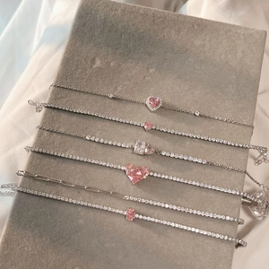 Detail of S925 silver tennis bracelets with pink heart and oval cubic zirconia stones