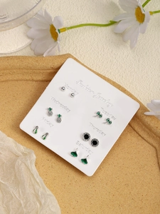 Detailed close-up of a 6-pair weekly stud earring set on a branded display card