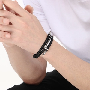 Close-up of black multilayer braided leather bracelet with stainless steel clasp on wrist