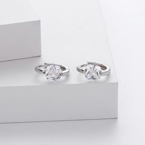 Macro detail of silver S925 earrings featuring square clear zircon in a bezel setting