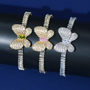 Detailed close-up of butterfly bracelets featuring sparkling zircons in gold and silver finish