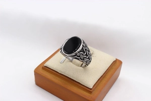 Macro view of vintage silver ring with oval black gemstone and Celtic knot engravings