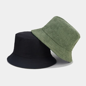 Detail view of corduroy and cotton bucket hats showing texture and stitching details