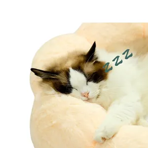 Plush round flower-shaped pet bed in coral fleece with a sleeping cat inside