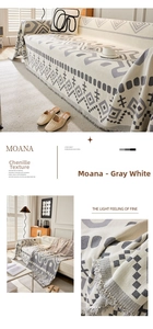 Macro detail of Bohemian chenille sofa throw with grey geometric patterns and fringe