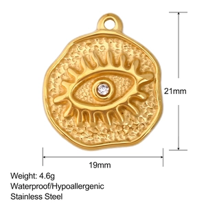Macro detail of gold stainless steel eye pendant with hammered texture and dimensions