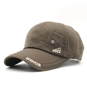 Detailed close-up of brown cotton baseball cap with GSIOR embroidery and metal badge