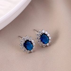 Elegant sun flower stud earrings with blue oval stones and white zircon halo in silver