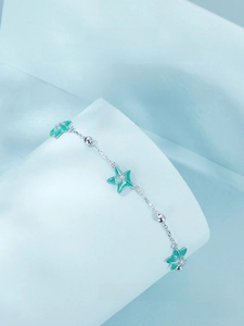 Macro shot of S925 sterling silver starfish bracelet with blue enamel details