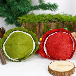 Close-up of colorful felt Christmas treat bags with pom-pom decor and wavy edges
