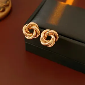 Chic twisted knot gold earrings with polished interlocking rings for stylish women