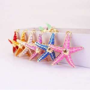Colorful enamel starfish keychains in six vibrant colors with golden metal ring hooks