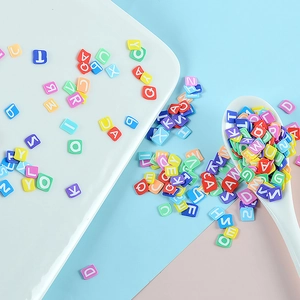Colorful mixed square alphabet beads for DIY jewelry making in a white ceramic dish