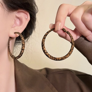 Chic leopard print geometric hoop earrings for women shown worn on a model in soft lighting