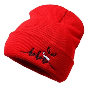 Red knit Christmas beanie with reindeer horns and hohoho embroidery for winter warmth