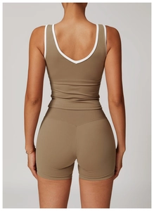 Detailed back view of high-waist yoga shorts and U-back vest with white piping trim