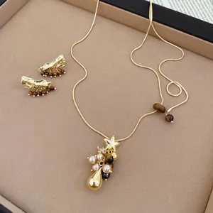Parure bijoux vintage dorée avec pendentif étoile, perles œil de tigre et collier